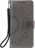 A gray flip phone case with a mandala pattern embossed on it. Produktbild-Vorschau