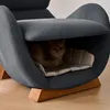 A cat is resting inside a unique, modern chair designed with a built-in cat bed. Náhled obrázku produktu