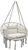 A white macrame hanging chair with ecru cushions, suspended by ropes against a white background. Podgląd zdjęcia produktu
