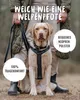 A person is standing behind a dog wearing a harness, with text overlays highlighting product features. Produktbild-Vorschau