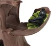 A close-up of a toy gorilla lying on a leaf in a tree-like structure. Anteprima dell’immagine prodotto