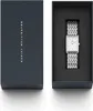A Daniel Wellington watch is shown in its packaging next to the product box. Voir les images du produit