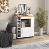 A kitchen cart is placed next to a sofa in a living room setting, with decorative items on top. Podgląd zdjęcia produktu