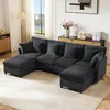 A U-shaped sectional sofa with multiple cushions is arranged in a living room setting, with a lamp, a cabinet with decorative items, and a painting on the wall visible in the background. Anteprima dell’immagine prodotto