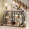 A console table with decorative items placed on it, positioned next to a staircase. Podgląd zdjęcia produktu