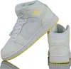 A pair of white and yellow Nike Air Jordan 1 Mid sneakers are shown against a white background. Podgląd zdjęcia produktu