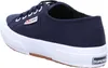 A side view of a navy blue Superga sneaker with a white sole and brown outsole. Produktbild-Vorschau
