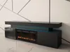 A modern black TV stand with an integrated electric fireplace and blue LED lighting, set against a white wall with geometric patterns. Produktbild-Vorschau