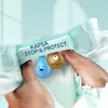 Hands holding a diaper with cartoon characters representing liquid and a mess. Anteprima dell’immagine prodotto