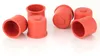 A group of red rubber caps on a white background. Produktbild-Vorschau