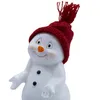 A close-up of a decorative snowman figurine wearing a red knitted hat. Produktbild-Vorschau