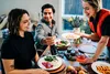 People at a dinner table with food and drinks. Náhled obrázku produktu