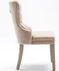 Side view of a beige upholstered dining chair with wooden legs. Voir les images du produit