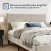 A bed with pillows and blankets, with a nightstand and lamp in the background. Voir les images du produit