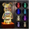 A large, illuminated teddy bear lamp is shown on the left, with smaller circular images of the same lamp in various colors on the right. Voir les images du produit