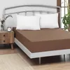 A bed with a brown fitted sheet and two white pillows. Produktbild-Vorschau