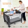 A mother is playing with her baby in a travel crib. Náhľad obrázku produktu