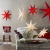 A cozy living room scene decorated for the holidays with star-shaped lanterns. Produktbild-Vorschau