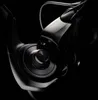 A close-up, dramatic studio shot of a fishing reel. Náhled obrázku produktu