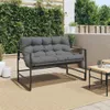 A garden bench with cushions on a patio with greenery in the background. Náhled obrázku produktu