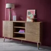 A wooden sideboard with slatted doors, decorated with a lamp, a speaker, books, and artwork. Anteprima dell’immagine prodotto