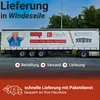 A truck trailer with promotional text and images, advertising delivery services for firewood and related products. Produktbild-Vorschau