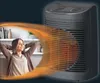 A woman relaxing in a room with a heater blowing warm air. Anteprima dell’immagine prodotto