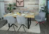 A dining room setting with a wooden table and chairs. Produktbild-Vorschau