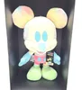 A tie-dye Mickey Mouse plush toy is displayed in a black box. Voir les images du produit