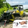 A yellow and black ATV is stuck in mud, with a red tow rope attached to its front. A smaller inset image shows a wired remote control for the winch. Podgląd zdjęcia produktu