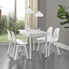 A dining set with a white table and four white chairs, set in a room with a large window and curtains. Anteprima dell’immagine prodotto