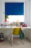 A child's desk with various items on it, including a roller blind covering a window. Produktbild-Vorschau