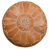 A round, brown leather pouf with white stitching and a star-like pattern in the center, presented on a white background. Voir les images du produit
