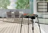 An outdoor patio scene with a grill and dining set. Náhled obrázku produktu