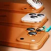 Multiple orange iPhone bodies are stacked, with camera lens protectors being applied to the bottom one. Anteprima dell’immagine prodotto