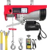 A red electric hoist with various accessories laid out around it, including straps, hooks, and a remote control. Produktbild-Vorschau
