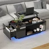 A modern living room with a couch and a coffee table. The coffee table has a laptop and books on it, and it has LED lighting underneath. Produktbild-Vorschau