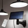 A solar-powered hanging lamp with a remote control, shown mounted on a wall. Produktbild-Vorschau