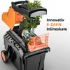 A garden shredder with its internal components exposed, showing plants being processed. Produktbild-Vorschau
