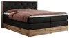 A king-size boxspring bed with a tufted headboard and a wooden base, shown from a side angle. Produktbild-Vorschau
