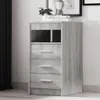 A gray Sonoma oak effect sideboard with drawers and an open shelf compartment, placed against a light gray wall with a black curtain on the left. Anteprima dell’immagine prodotto