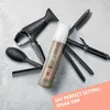 A collection of hair styling tools and a hair spray product are arranged on a light gray surface. Produktbild-Vorschau
