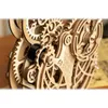 Close-up view of a wooden mechanical clock owl model with intricate gears. Produktbild-Vorschau