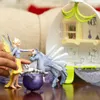 A child's hands are playing with fairy and pegasus toys in front of a toy playset. Anteprima dell’immagine prodotto