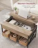 A lift-top coffee table with storage, shown in an open state with items inside, and a laptop on top. Produktbild-Vorschau
