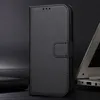 A black flip-style phone case is shown in a studio setting with a laptop in the background. Náhled obrázku produktu