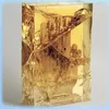 A rectangular block of clear resin with golden, abstract inclusions, resembling a sculpture or decorative item. Voir les images du produit