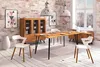 A dining room scene with a wooden table and chairs, a cabinet, and decorative elements. Produktbild-Vorschau