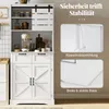 A white kitchen cabinet with sliding barn doors on top, and two cabinet doors and two drawers on the bottom. There are inset images showing safety features. Podgląd zdjęcia produktu