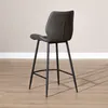A dark gray bar stool with black metal legs is shown from a side angle against a light gray wall and a wooden floor. Produktbild-Vorschau